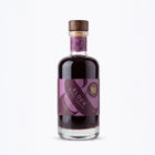 A bottle of Elder Black Forest elderberry liqueur with a purple label and a wooden stopper, shown on a clean white background.