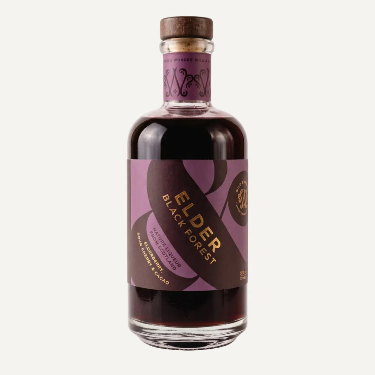 Bottle of Elder Black Forest by Wild & Wonder. In the bottle there is a dark liquid with a purple and dark purple label with gold lettering and a dark wooden stopper