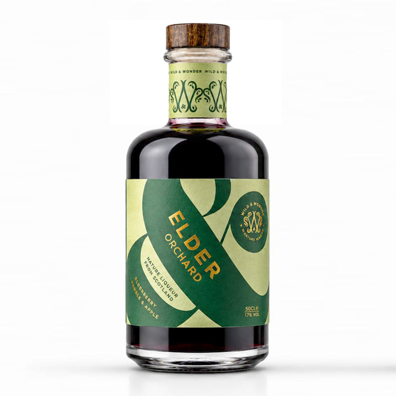 A 500ml bottle of Wild & Wonder Elder Orchard elderberry, bramble & apple liqueur with a green and light green label and wooden stopper, on a white background.