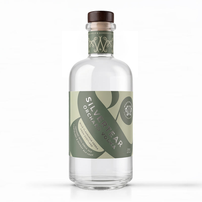 A bottle of Silvertear Orchard Vodka on a solid white background. The clear glass bottle features a dark brown wooden stopper and a label with olive green and light green graphics.