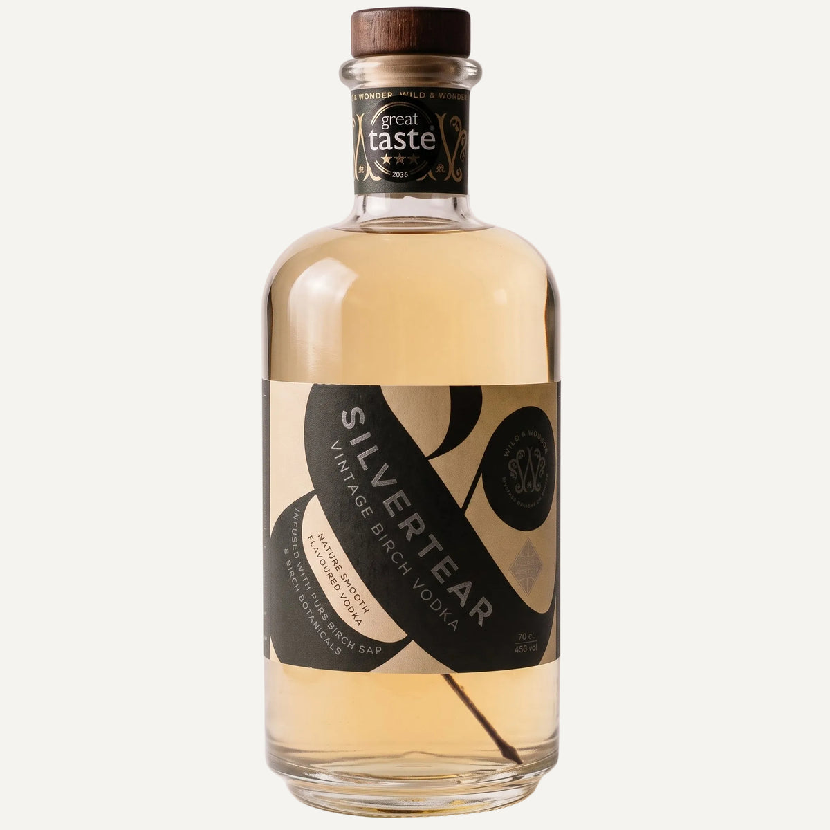 A bottle of Silvertear Vintage birch sap vodka with a dark green and beige label and wooden stopper, on a light grey background