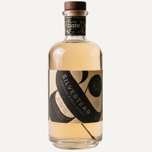 A bottle of Silvertear Vintage birch sap vodka with a dark green and beige label and wooden stopper, on a light grey background