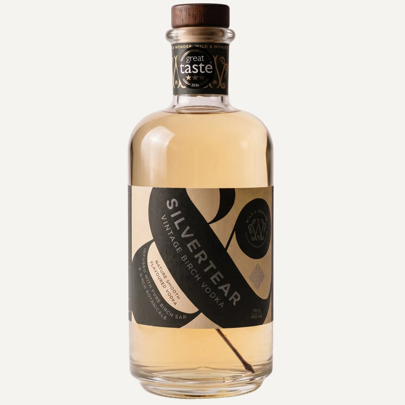 A bottle of Silver Tear Vintage BBirchVodka with a brown wooden cap and a dark green and beige label, shown against a light off-white background.