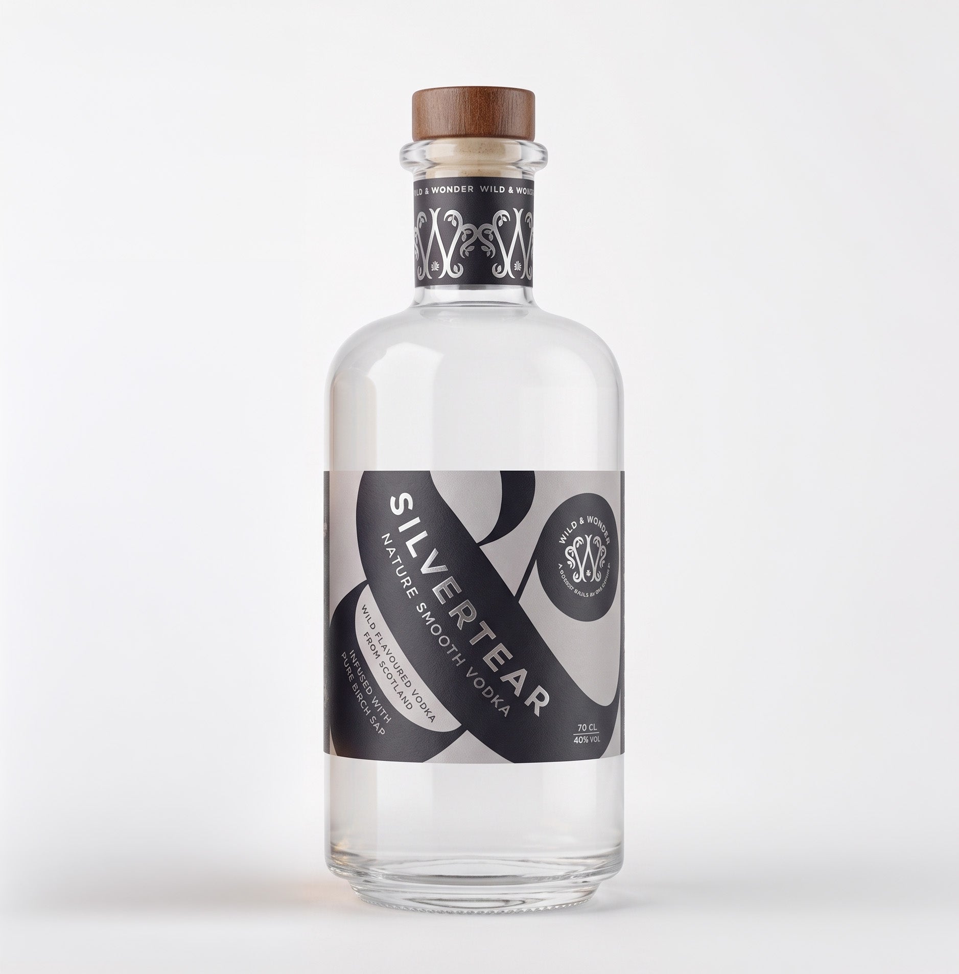 A clear glass bottle of Silver Tear Nature smooth birch sap vodka with a brown wooden cap, featuring a black and grey label with white text, set against a plain white background.