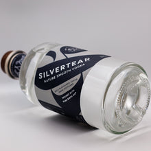 A bottle of Silvertear Nature vodka lying on its side on a white background