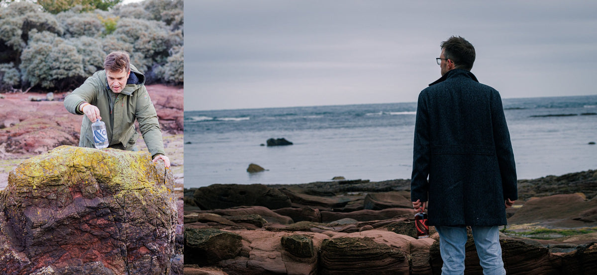 The founders out on the rocky shore, one crouching by the rocks and one looking out to sea